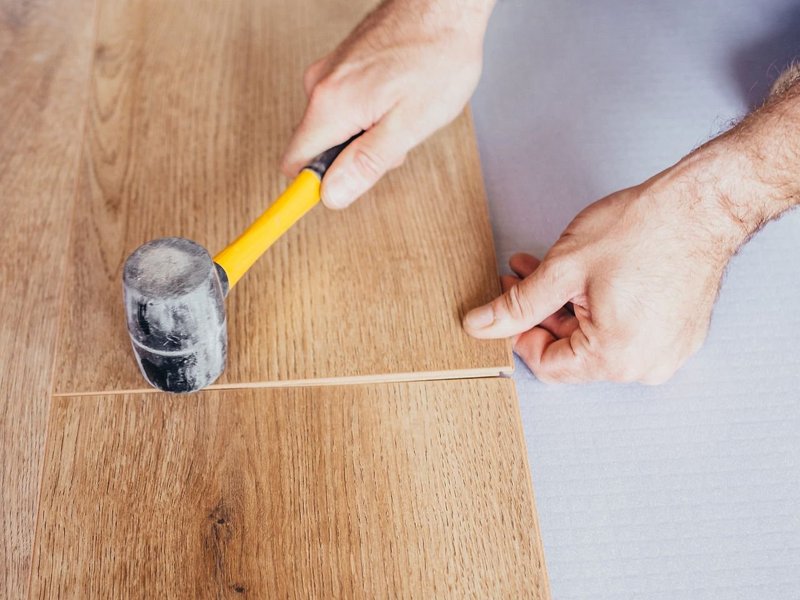 Person installing flooring from Flooring Source in the Auburn, MA area